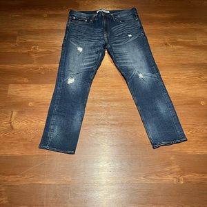 Dark blue express denim with a nice light fade and some distressed touches.